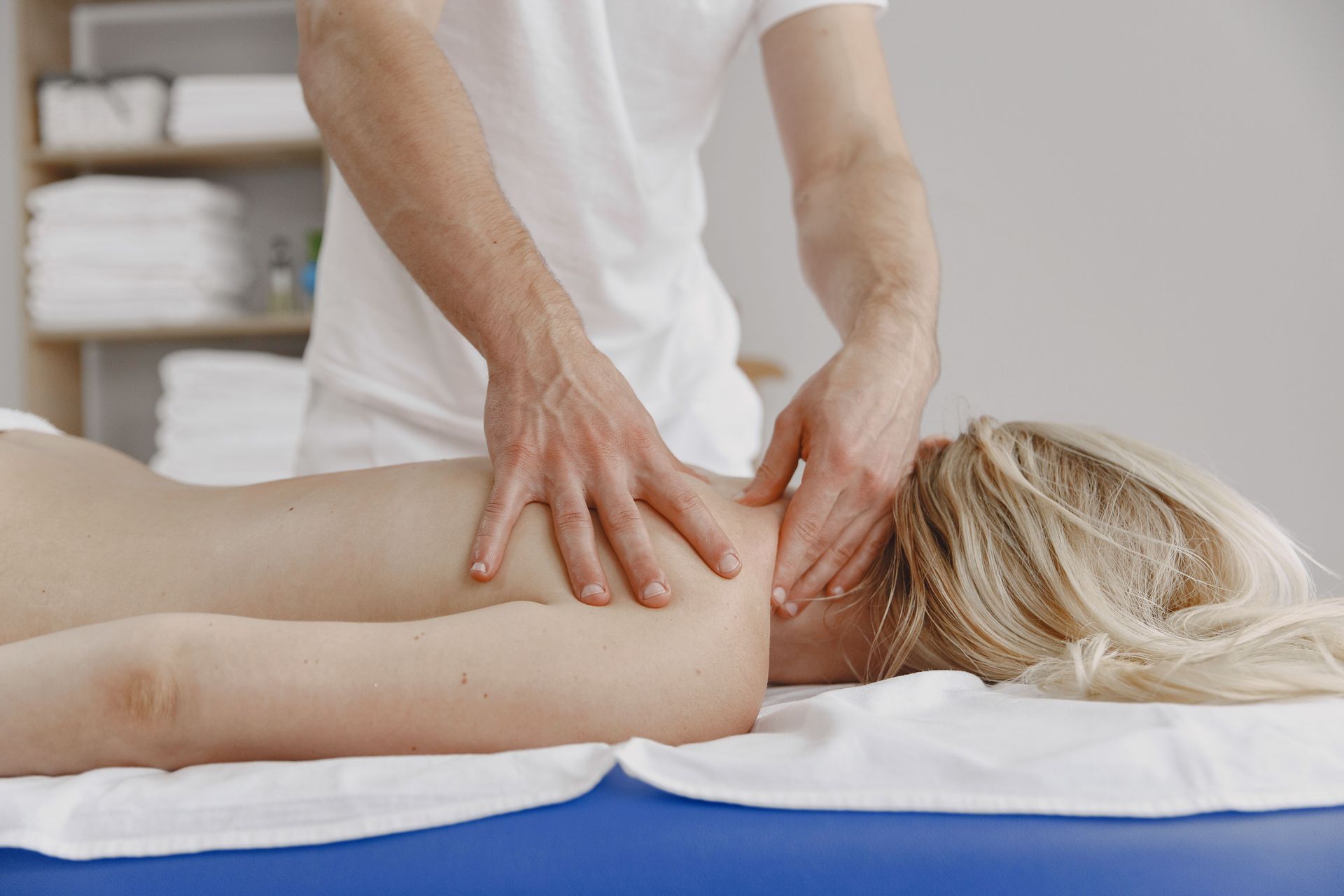 A tranquil massage session focusing on relaxation and self-care, featuring a woman receiving a back massage.
