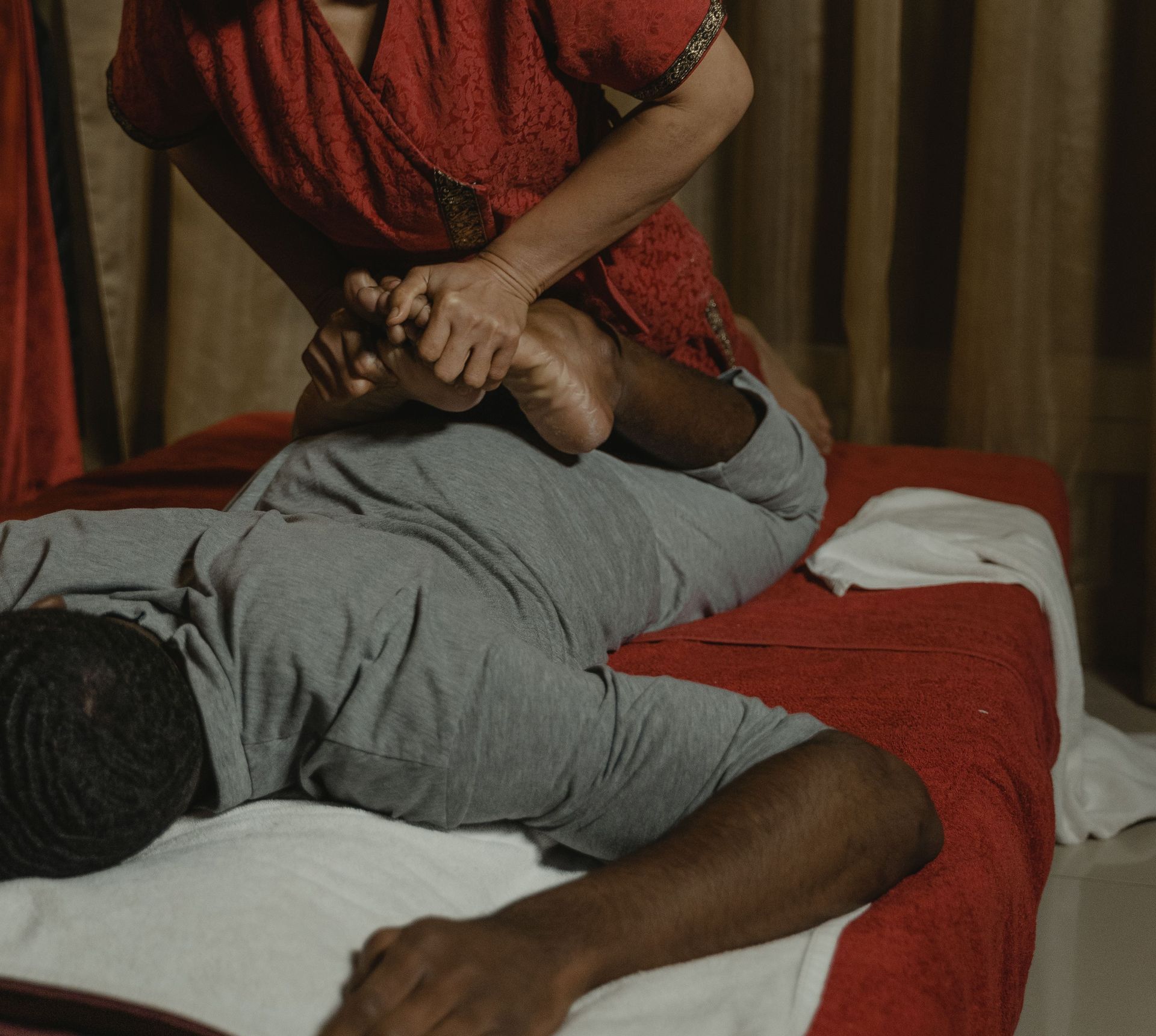 A soothing Thai massage in a tranquil room with an experienced therapist providing care.